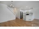 Open-concept kitchen with stainless steel appliances and a breakfast bar at 3648 Oakwood Dr, Longmont, CO 80503