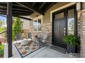 Cozy covered front porch with comfortable seating, a stylish rug, and beautiful decor at 3663 Silverton St, Boulder, CO 80301
