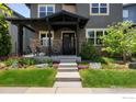 Inviting front porch with stone accents, steps to the entry, and professionally maintained landscaping at 3663 Silverton St, Boulder, CO 80301