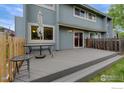 Exterior view of a home's back deck, perfect for outdoor entertaining with table, umbrella and sliding door entry at 4140 Monroe Dr # C, Boulder, CO 80303