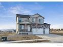 Charming two-story home with a three-car garage, stone accents, and mountain views at 4204 Sandstone Dr, Mead, CO 80504