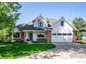Inviting two-story home with a covered front porch and well-maintained lawn at 426 W Spruce Ln, Louisville, CO 80027