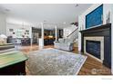 Open concept living area with fireplace flowing seamlessly into the kitchen and dining space at 4915 Sage Brush Dr, Broomfield, CO 80023