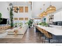 Open-concept living space with large island, lots of natural light and modern furnishings at 4940 Preserve Pl, Firestone, CO 80504