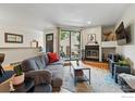 Cozy living room with a comfortable sofa, fireplace, and sliding door to the outdoor patio at 5016 Buckingham Rd # 4, Boulder, CO 80301