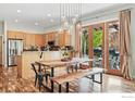 Bright dining area features wood floors, modern lighting, and access to an outdoor patio at 5145 Denver St, Boulder, CO 80304