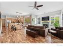 Open-concept living room with hardwood floors, fireplace, and a seamless connection to the kitchen at 5145 Denver St, Boulder, CO 80304