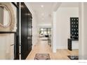 Inviting foyer with wood floors, black accents, and bright natural light at 633 Dexter St, Denver, CO 80220