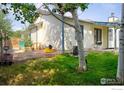 Backyard with lawn and small patio with grill at 730 Douglas Pl, Berthoud, CO 80513