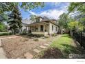 Attractive home with a welcoming front porch, complemented by a well-maintained lawn at 736 Kimbark St, Longmont, CO 80501