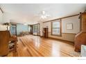 Spacious living room with beautiful hardwood floors, complemented by large windows for ample natural light at 736 Kimbark St, Longmont, CO 80501