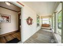 Inviting covered porch, featuring a swing and decorative wreath, offering a cozy outdoor space at 736 Kimbark St, Longmont, CO 80501