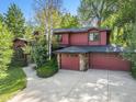 Spacious home featuring an attached garage and surrounded by mature landscaping at 7528 Estate Cir, Niwot, CO 80503