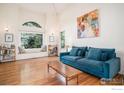 Sun-filled living room with hardwood floors, large windows, and comfortable seating at 7528 Estate Cir, Niwot, CO 80503