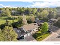 Scenic aerial view of home with mature trees, landscaping, and a two car garage at 794 W Elati W Cir, Littleton, CO 80120