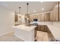 Well-lit kitchen featuring custom cabinets, stainless steel appliances, and a spacious quartz island at 834 W 128Th Pl, Westminster, CO 80234