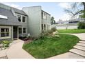 Inviting townhome featuring a well-manicured lawn, charming patio, and convenient parking at 93 Benthaven Pl, Boulder, CO 80305