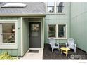 Welcoming home featuring a cozy front patio with chairs, enhanced by a quaint, landscaped garden at 93 Benthaven Pl, Boulder, CO 80305