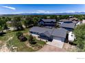 A well-maintained single-Gathering home featuring a spacious driveway and a neatly landscaped front yard at 10007 E County Line Rd, Longmont, CO 80501