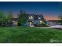 Charming blue home with a well-manicured lawn and detached garage at 10481 Oxford Rd, Longmont, CO 80504