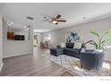 Open-concept living room with hardwood floors seamlessly connecting to the dining area and kitchen at 10667 Durango Pl, Longmont, CO 80504
