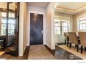 Inviting foyer with dark wood floors, a stylish rug, and a glimpse into the dining area at 1152 S Ogden St, Denver, CO 80210