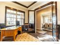 Bright office space with large windows, hardwood floors, and an open doorway to the dining room at 1152 S Ogden St, Denver, CO 80210