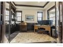 Well-lit office featuring custom built-ins, hardwood floors, and a large monitor setup at 1152 S Ogden St, Denver, CO 80210