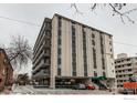 Exterior view of the condo building showing parking and multiple floors of residences at 1265 Race St # 408, Denver, CO 80206