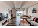 Bright and airy living room featuring hardwood floors and access to an outdoor space at 1265 Race St # 408, Denver, CO 80206
