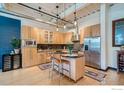 Contemporary kitchen with stainless steel appliances, a center island, and custom wood cabinetry at 1360 Walnut St # 202, Boulder, CO 80302