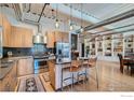 Modern kitchen featuring stainless steel appliances, a breakfast bar, and stylish pendant lighting and open floor plan at 1360 Walnut St # 202, Boulder, CO 80302