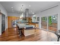 Gourmet kitchen with stainless steel appliances, center island, custom cabinets, and wood flooring at 1445 Moss Rock Pl, Boulder, CO 80304