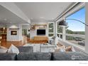 Bright living room with large windows, fireplace, hardwood floors, and open layout at 1445 Moss Rock Pl, Boulder, CO 80304