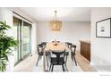 Elegant dining area with a modern light fixture and sliding glass doors at 1560 Kendall Dr, Boulder, CO 80305