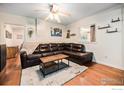 Cozy living room featuring a comfortable leather couch and hardwood floors, perfect for relaxation at 159 Virginia Canyon Rd, Idaho Springs, CO 80452