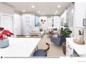 Open-concept living room with contemporary furniture, neutral tones, and abundant natural light at 1606 W 166Th Ave, Broomfield, CO 80023