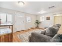 Bright living room features hardwood floors, a comfortable couch, and lots of natural light at 1970 Willow St, Denver, CO 80220