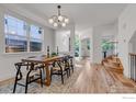 Spacious dining room with hardwood floors, large windows, and modern chandelier at 2055 S Columbine St, Denver, CO 80210