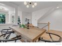Bright dining room with wood table and stairs at 2055 S Columbine St, Denver, CO 80210