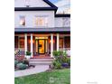 Close-up of the home's brick facade, white columns, and walkway leading to the front door at 2835 Links Dr, Boulder, CO 80301