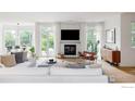 Stylish living room with white furniture, a stone fireplace, and an abundance of natural light at 2835 Links Dr, Boulder, CO 80301