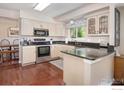 Well-equipped kitchen featuring stainless steel appliances and dark countertops at 2935 Bow Line Pl, Longmont, CO 80503