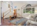 Bright living room with high ceilings, large windows, and hardwood floors at 2935 Bow Line Pl, Longmont, CO 80503