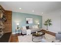 Well-lit living room with hardwood floors, decorative fireplace, and neutral-toned furniture at 319 Carter Ln, Longmont, CO 80501