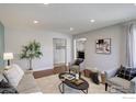 Bright living room with hardwood floors, neutral decor, and comfortable seating arrangement at 319 Carter Ln, Longmont, CO 80501