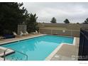 Community pool surrounded by a fence at 33 S Boulder Cir # 122, Boulder, CO 80303