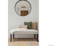 Hallway bench with decorative pillows and round mirror creates a welcoming entryway at 3301 Arapahoe Ave # 219, Boulder, CO 80303