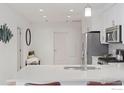 Clean, bright kitchen featuring white cabinets, stainless appliances and a spacious quartz countertop at 3301 Arapahoe Ave # 219, Boulder, CO 80303
