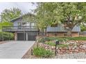 Charming exterior of a two-story home with mature trees and front yard landscaping at 3410 Heidelberg Dr, Boulder, CO 80305